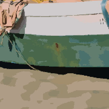 The same prediction cleaned up: smooth sand and hull, with the rope and the edge of the boat still sharp.