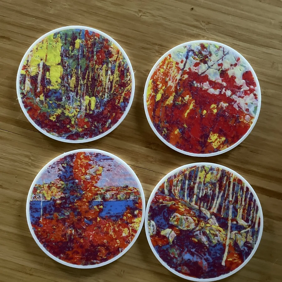 Four of my Polychrome coasters of Tom Thomson autumn paintings on a bamboo table