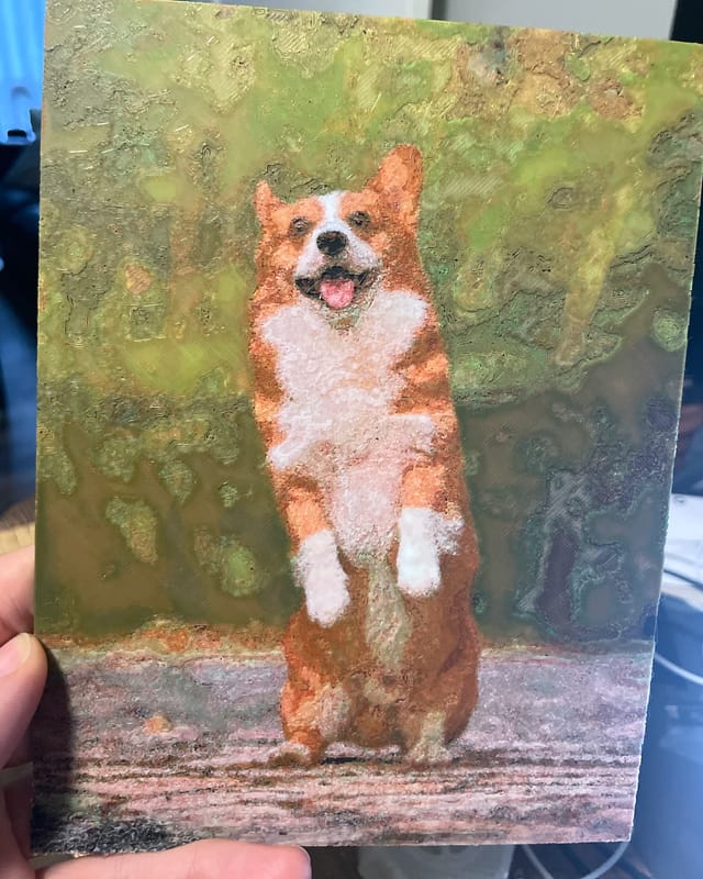 My Polychrome print of a corgi puppy standing on its back legs, held in my hand