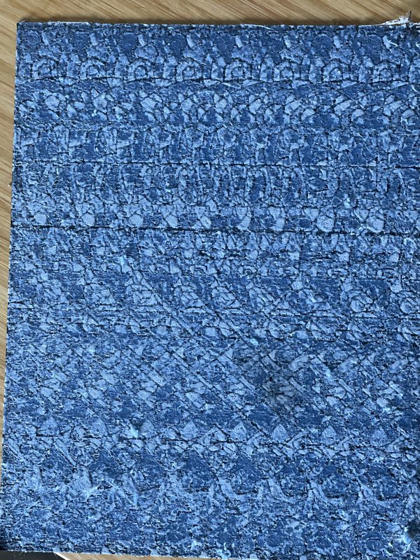 A flat plate printed with a dense blue and white repeating pattern, a Magic Eye picture with a shape hidden in it